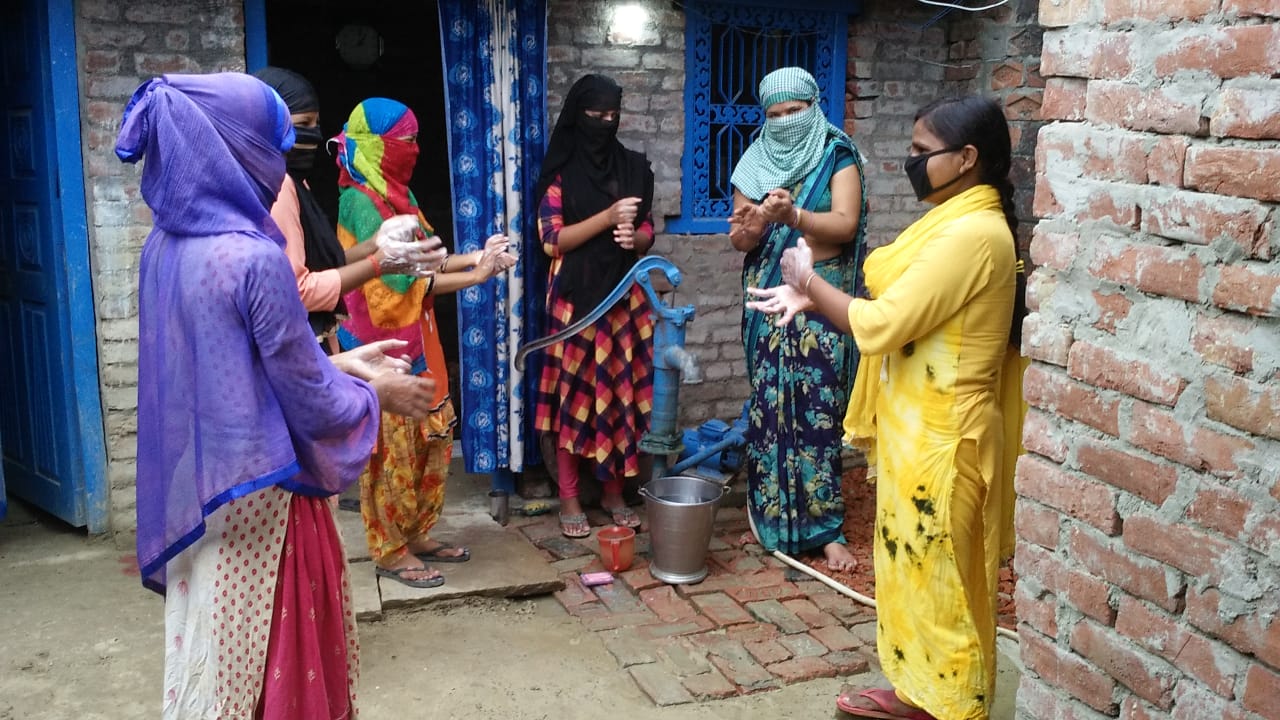 Women participating in a hand washing demo