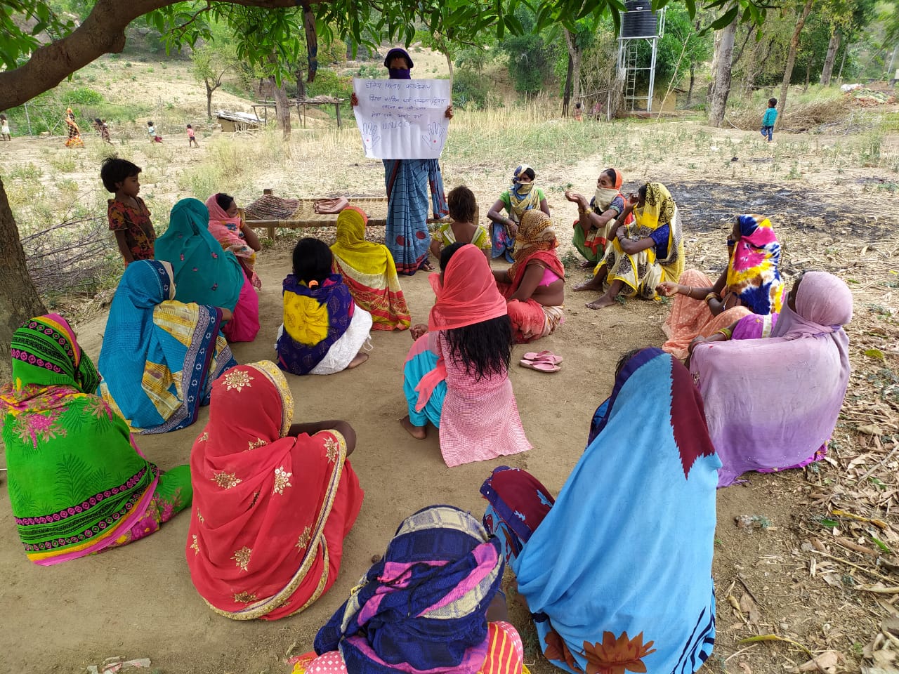 Women in circle receiving lesson from a health leader
