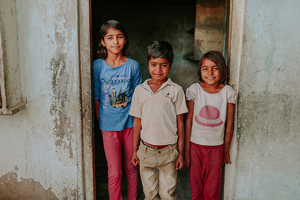 Children in the doorway of their home in Rajasthan, India. © Kim Landy