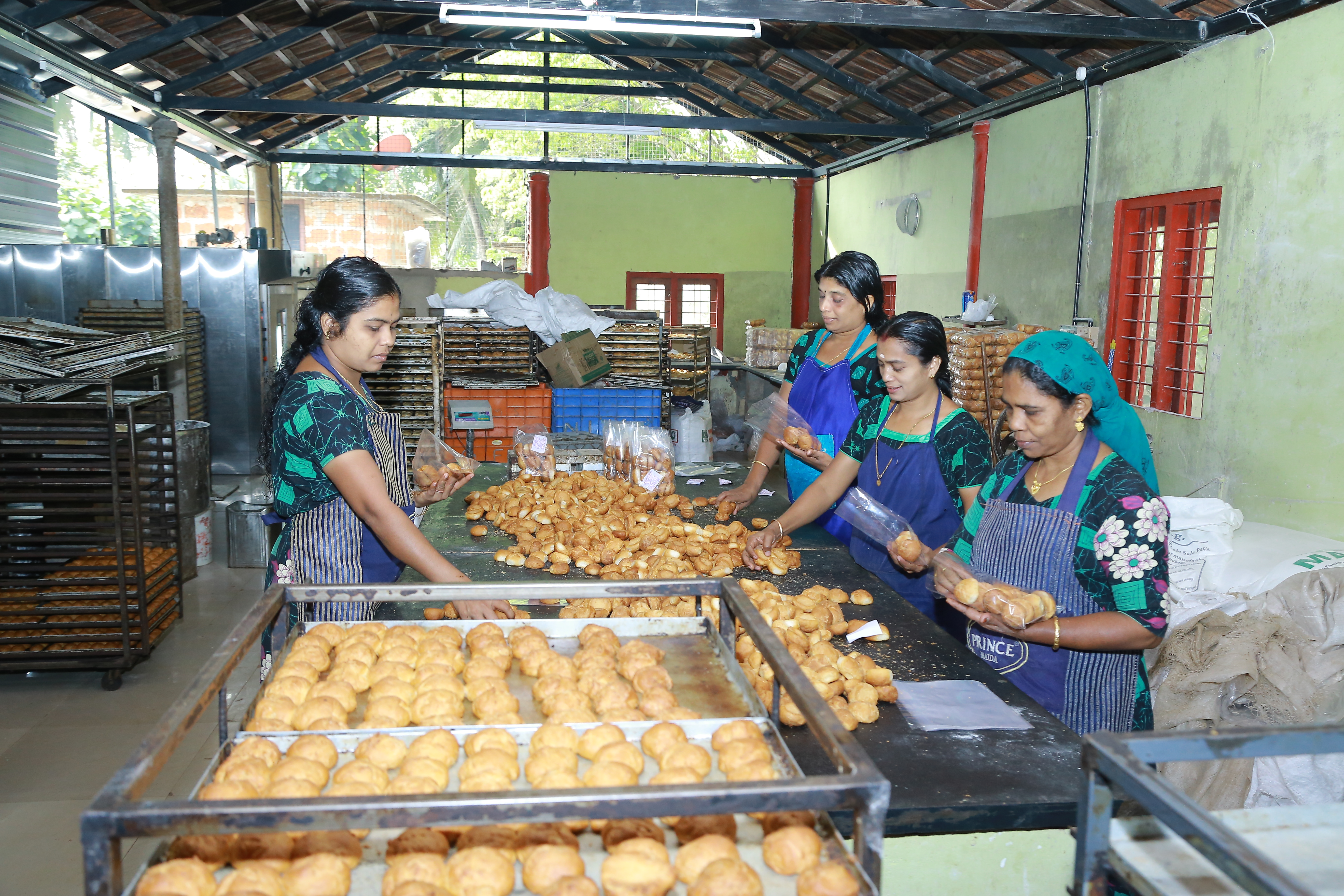 Indian women learning to make cookies and buns