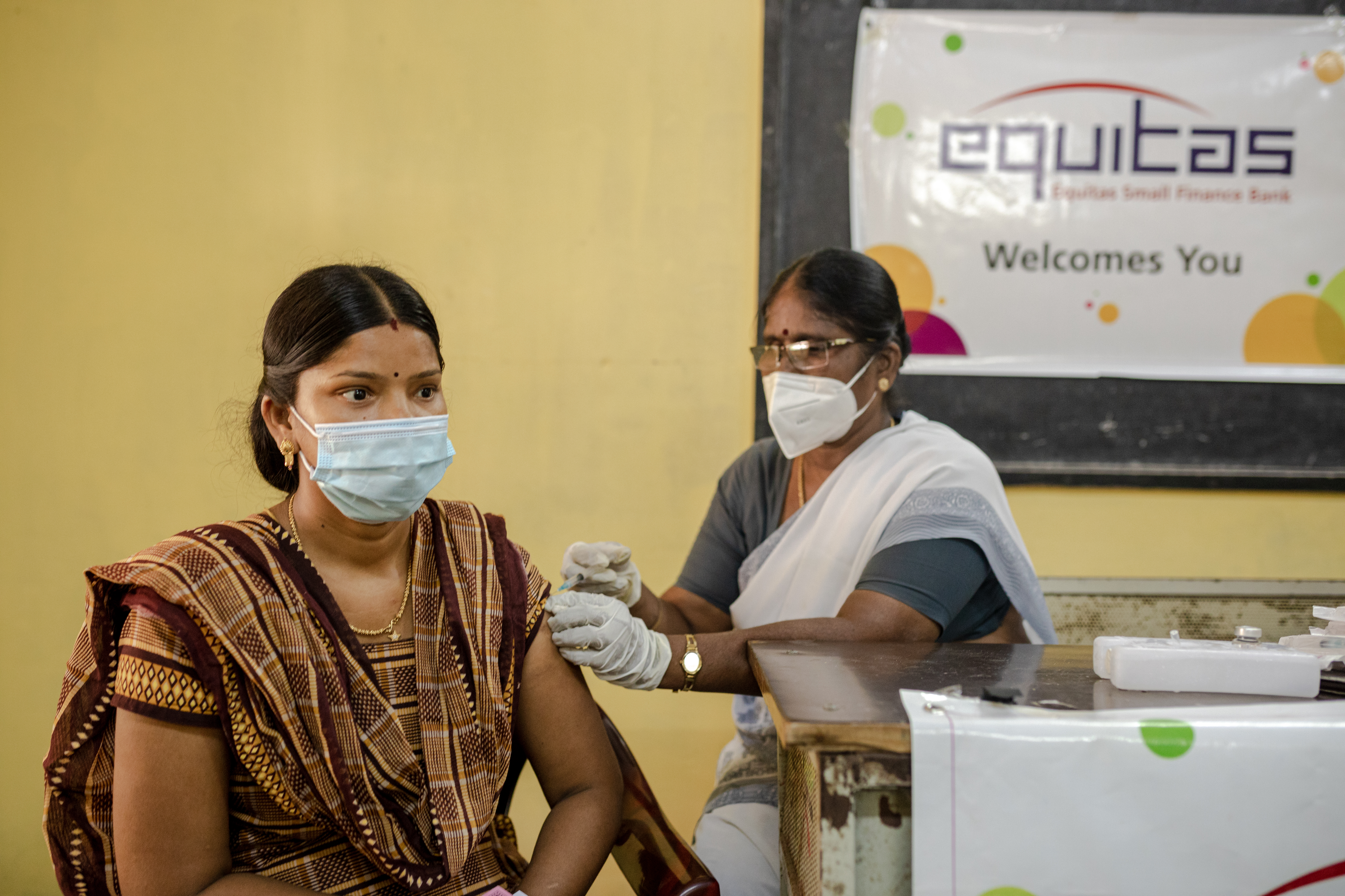 A female is vaccinated against COVID-19 by Equitas