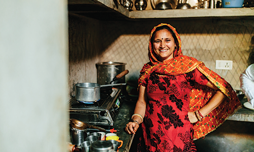 Vanadana, an Opportunity client, cooking in her kitchen