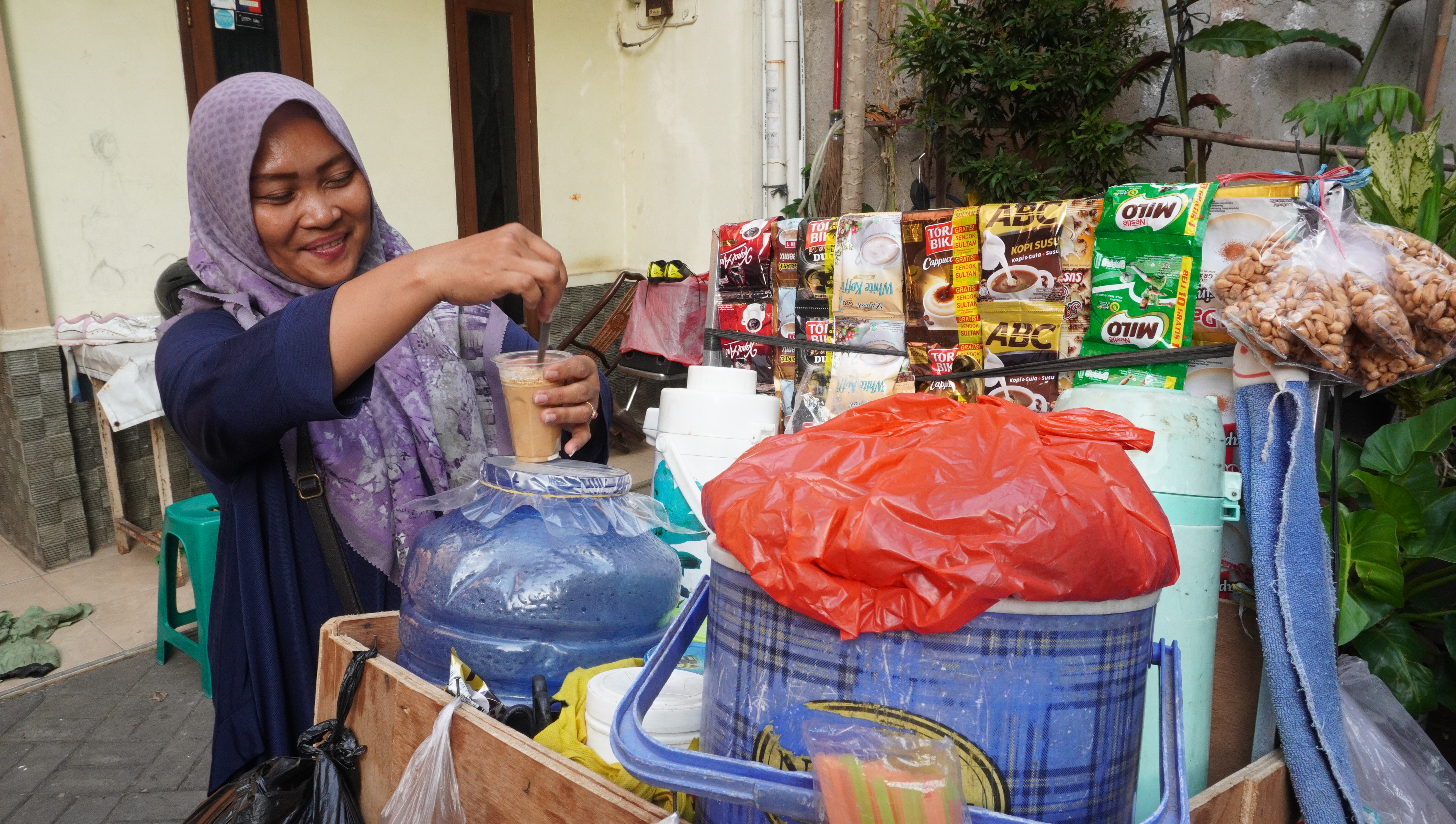 Lis serving coffee from her motorbike cart
