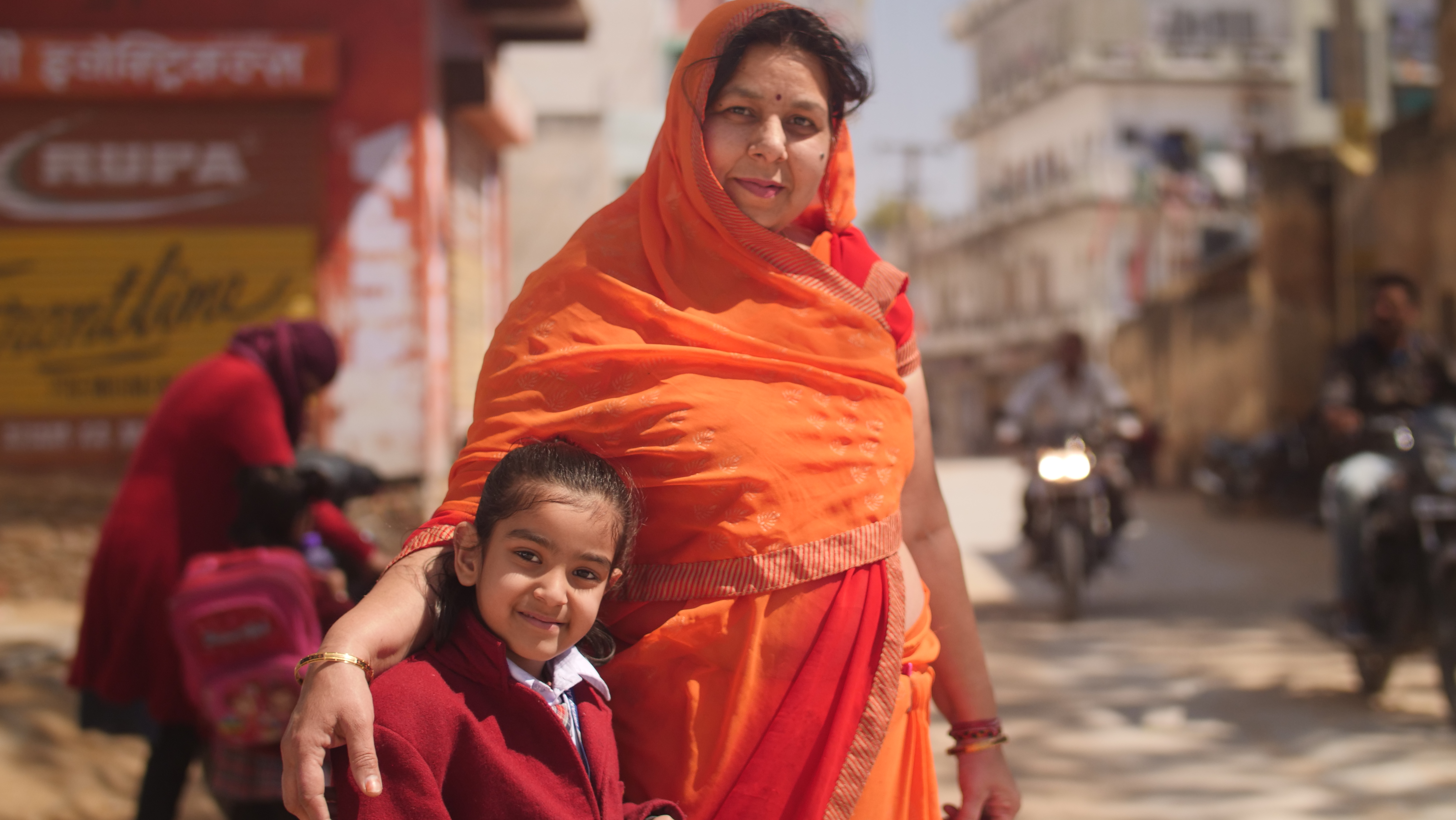 A parent sending her child to school with the help of a school loan