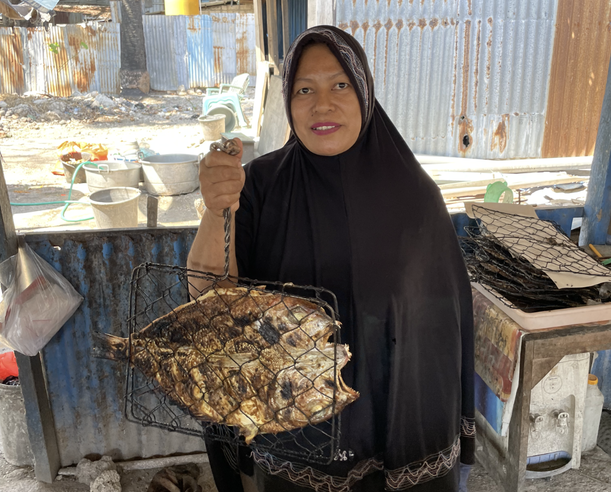 Nur with a grilled fish she prepared