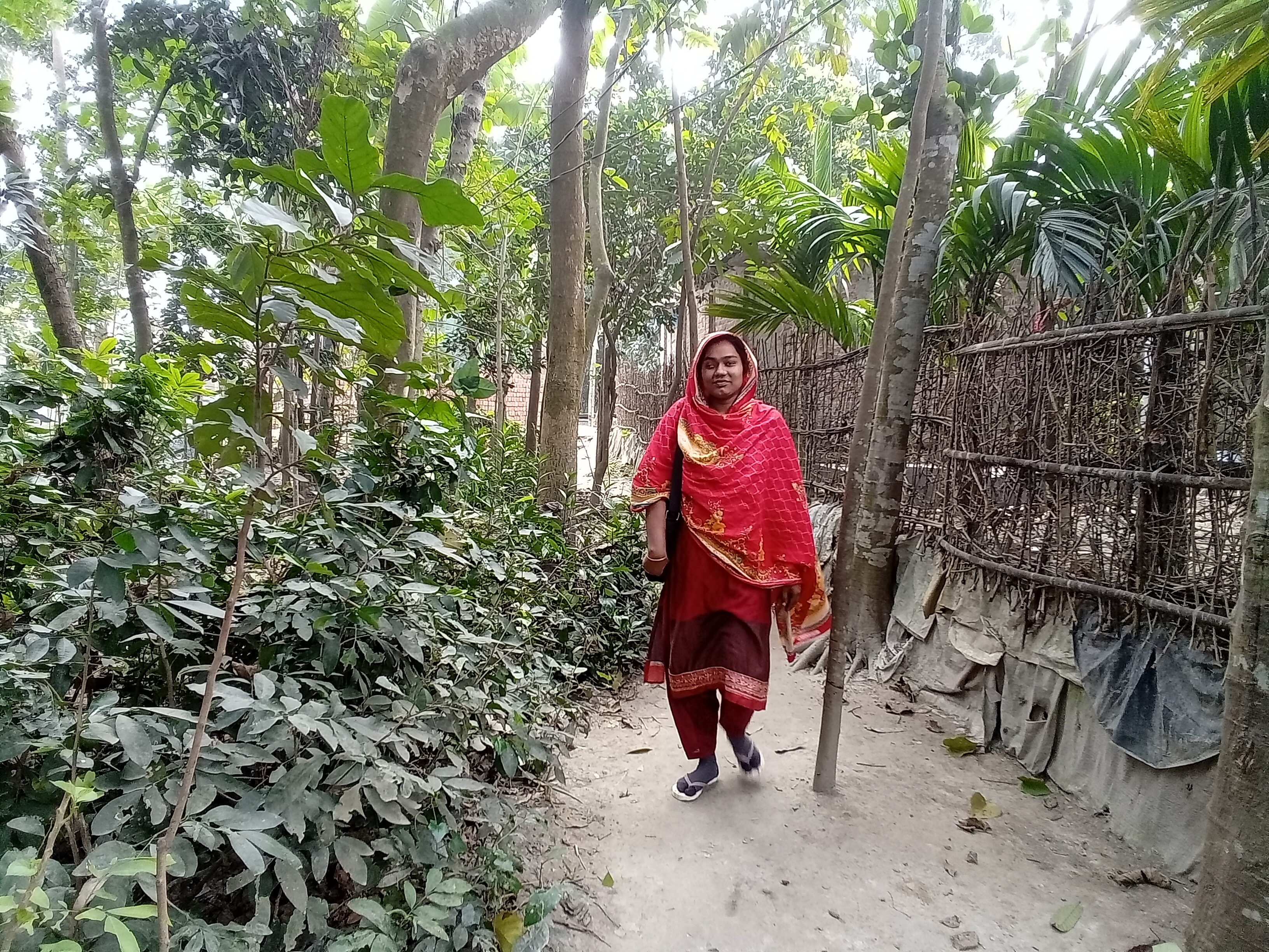 Hafzarun walks through her village